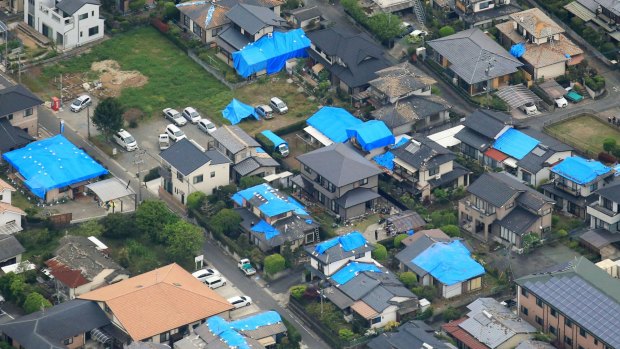 Earthquake damaged houses are covered with blue plastic sheets in Mashiki, Kumamoto prefecture.
