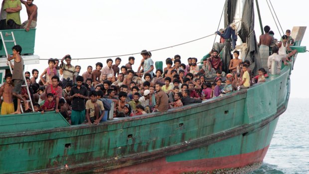 Migrants including Myanmar's Rohingya Muslims wait to be rescued by Aceh fishermen off Indonesia last year.