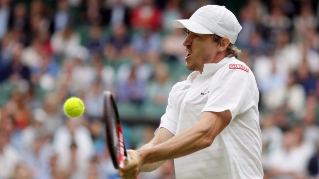 John Millman returns to Andy Murray during their match on day six of Wimbledon.
