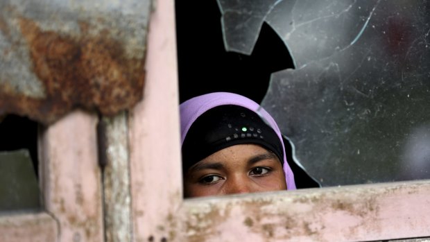 An ethnic Rohingya woman looks out from a window at a temporary shelter in Indonesia in May. 
