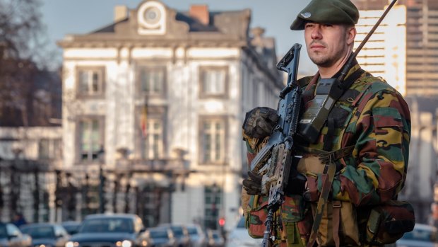 A Belgian para-commando patrols near the office of the prime minister in Brussels.
