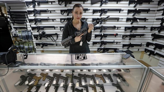 Gun shop owner Tiffany Teasdale-Causer poses with a Ruger AR-15 semi-automatic rifle in Lynnwood, Washington. Gun-rights supporters have seized on the Texas church massacre as proof of the idea that the best answer to a bad guy with a gun is a good guy with a gun.