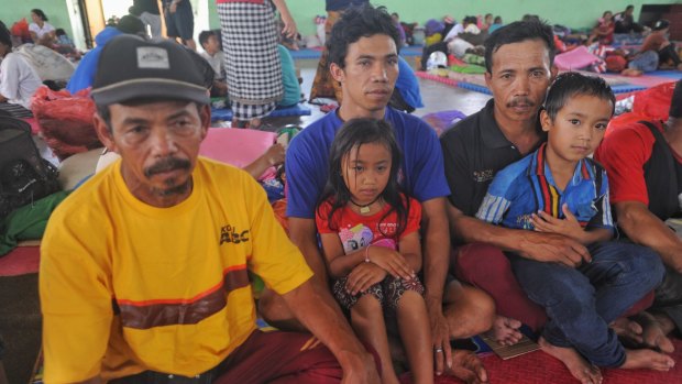 Kadek Nadi, centre, and his family have evacuated from Mount Agung.