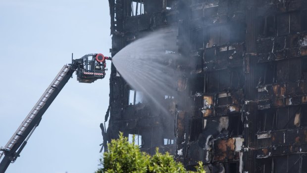 Firefighters battle the Grenfell Tower blaze from the ground.