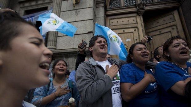 Protesters sing the national anthem in Guatemala City after the vote.