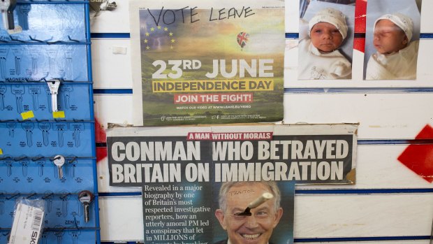 A fork sticks out of a photograph of former prime minister Tony Blair on a newspaper cutting at a shoe repair shop in Sunderland.