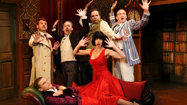 In front: Darcy  Brown (Lying down, purple jacket); Brooke Satchwell (in red dress); rear, from left: Nick Simpson-Deeks ( Trench coat); George Kemp ( moustache); Luke Joslin ( mustard check waistcoat); James Marlowe ( Striped blazer) in <i>The Play That Goes Wrong</i>. 