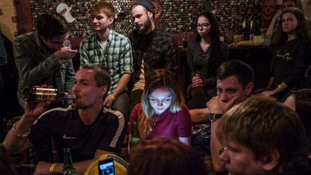 Young people listen to a rock band at the popular Zaboi (The Face) bar, the only establishment in the city that has its own brewery, in Norilsk, Russia.