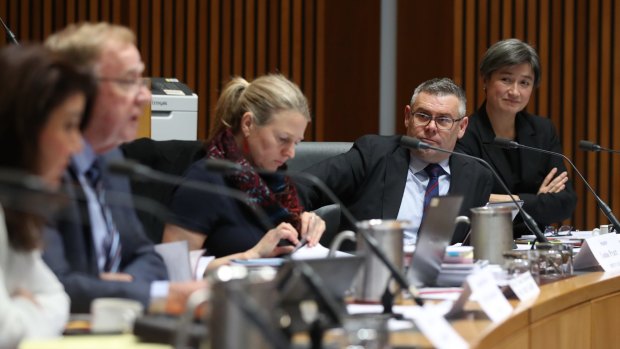 Senators Murray Watt and Penny Wong with committee chair Senator Ian Macdonald during  a committee hearing on Thursday.