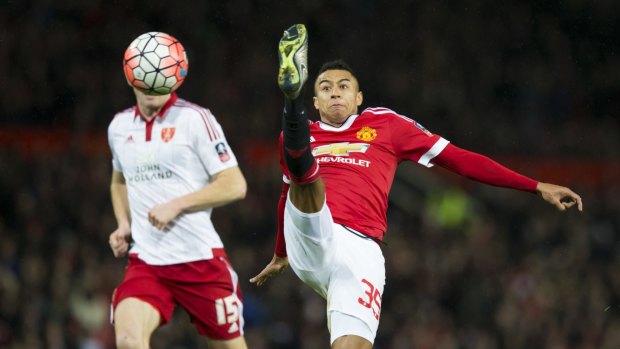 High kicks: Manchester United's Jesse Lingard fights for the ball against Sheffield United's Neill Collins.