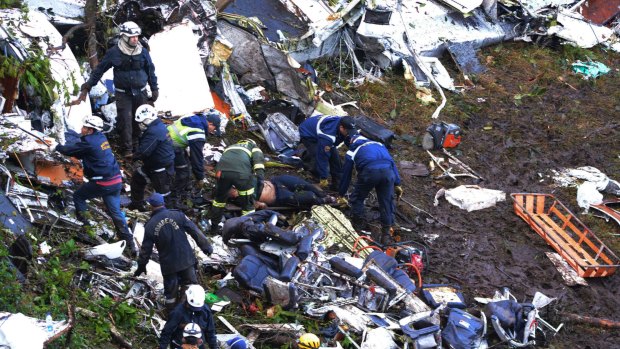 Rescue workers search for survivors at the wreckage site.