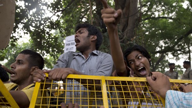 Indian male and female students shout slogans during a protest against the latest incidents of rape in New Delhi on Sunday.