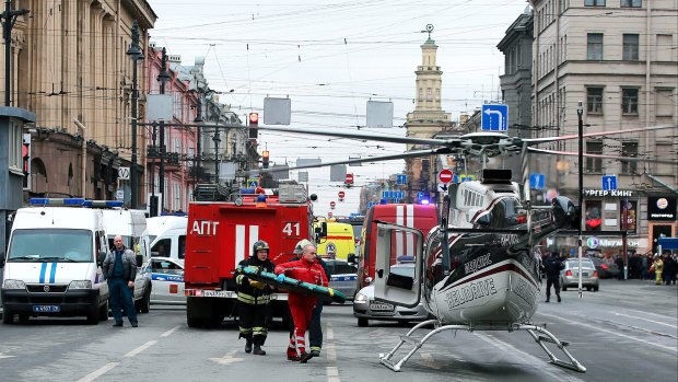 Paramedics carry a stretcher from a helicopter after the explosion in St Petersburg.