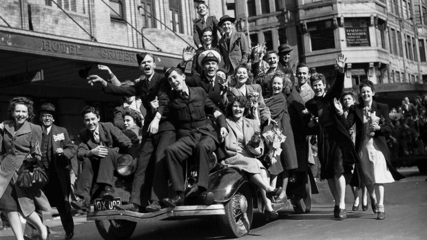 Plunging headlong and full-throatedly into celebration ...Revellers hitch a ride up Park Street. 
