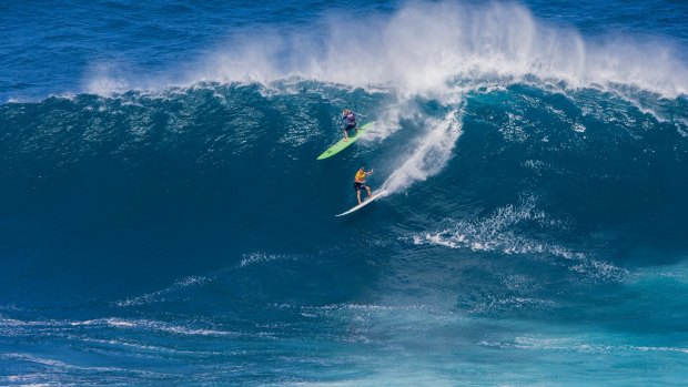 Laura Enever, upper left, and Felicity Palmateer, ride a wave at a Maui surf break known as "Jaws" in Haiku, Hawaii, on November 11 last year. 