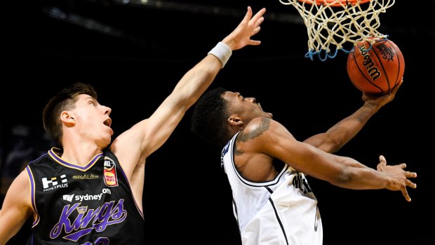 Up and under: Carrick Felix of United attacks the basket against the Sydney Kings at Qudos Bank Arena.