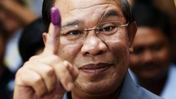 Ink print: Prime minister Hun Sen, once in the Khmer Rouge, photographed voting in 2013.