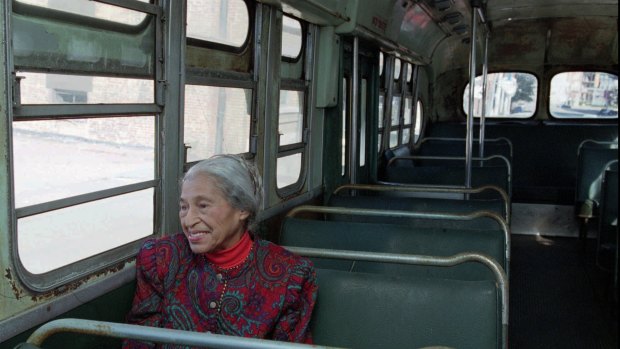 Civil rights pioneer Rosa Parks sits in a 1950s-era bus in Montgomery, Alabama, in 1995, 40 years after she was arrested for refusing to give up her seat to a white person.