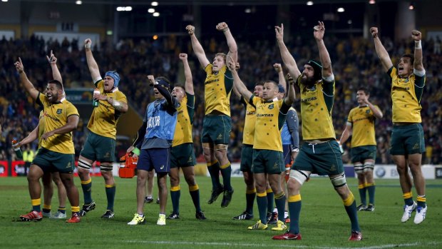 You beauty: The Wallabies celebrate as they watch a replay confirming Tevita Kuridrani had scored a controversial try at the end of their Rugby Championship match against South Africa's Springboks in Brisbane.