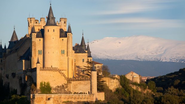 Alcazar castle and snow-capped mountains.