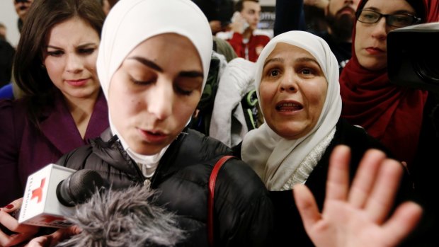Mariam Yasin, left, translates for her mother Najah al-Shamieh, 55, from Syria, after immigration authorities released her.