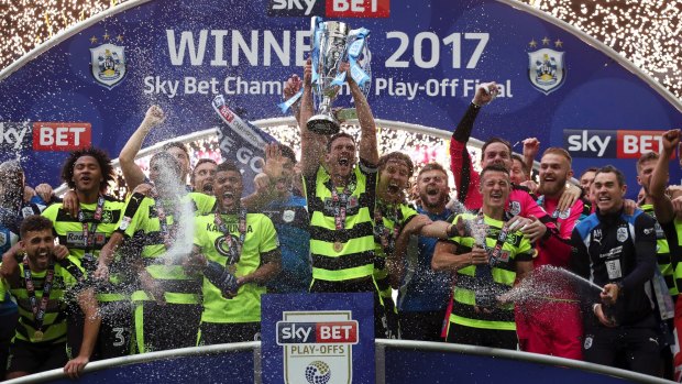 Huddersfield Town's Mark Hudson lifts the trophy after winning the Championship play-off final at Wembley.