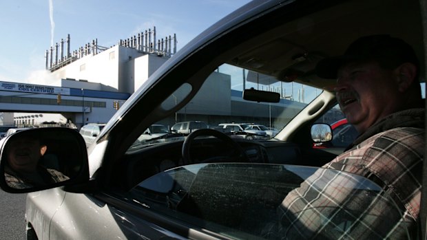 A worker arrives for his shift at the Chrysler factory in Windsor, Ontario. 