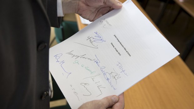 The deal: Martin Schaefer, press officer of the German Foreign Ministry holds a signed copy of the Joint Comprehensive Plan of Action regarding Iran's nuclear program.