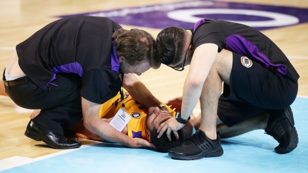 Scary moment: Medical staff assess Kevin Lisch on court.