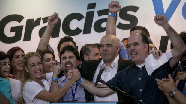 Opposition leaders, from left to right, Lilian Tintori, wife of jailed Venezuelan opposition leader Leopoldo Lopez, Freddy Guevara, of the Voluntad Popular party, Jesus Torrealba, head of the Democratic Unity Movement (MUD) party and deputy Julio Borges celebrate in Caracas.