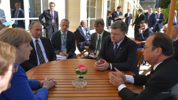 Sitting round a table for talks are from left, clockwise: German Chancellor Angela Merkel, Russian President Vladimir Putin, Ukrainian President Petro Poroshenko and French President Francois Hollande, in Paris on Friday.