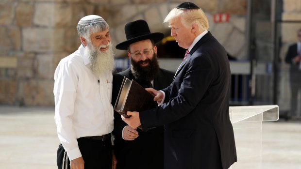 Shmuel Rabinowitz, rabbi of the Western Wall, centre, with US President Donald Trump during his visit to the site in May.