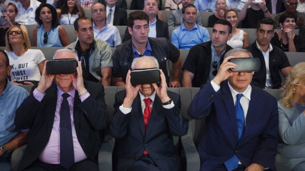 Israeli President Reuven Rivlin, left, Shimon Peres, centre and Israeli Prime Minister Benjamin Netanyahu, wear virtual reality goggles during a ceremony at the Peres Centre for Peace in Jaffa in July.