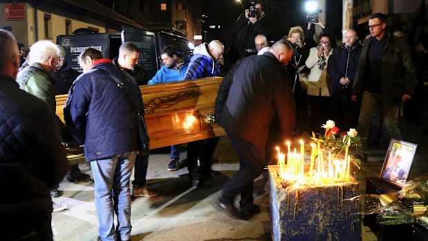 People carry the coffin of Oliver Ivanovic outside his office in the northern, Serb-dominated part of Mitrovica, Kosovo.