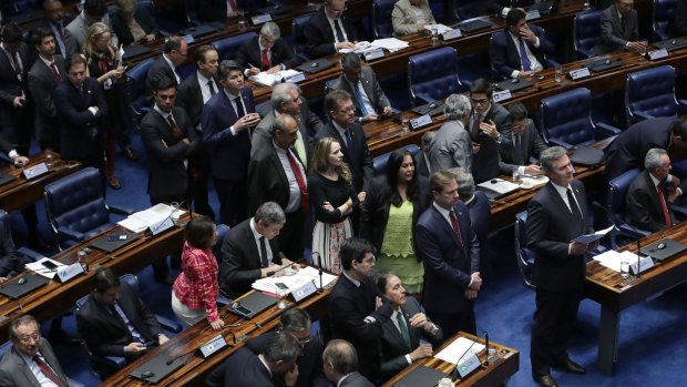 A line of senators form behind Brazil's former President Fernando Collor de Mello, for a chance to speak at the final session in the impeachment trial.