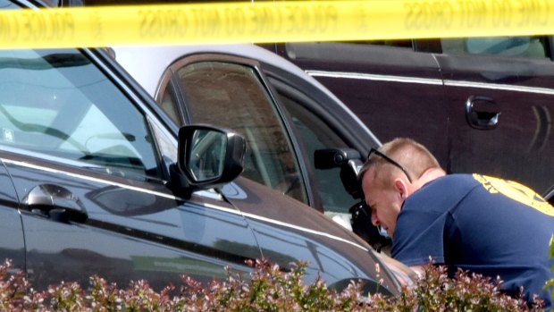 The crime scene is photographed by investigators at the Huntington Bank, next to the Courthouse, in Steubenville, Ohio.
