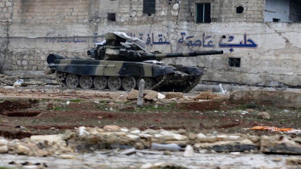 A Syrian army tank is seen in front of a wall bearing the legend "Aleppo is the capital of culture" in the east Aleppo neighbourhood of Tariq al-Bab earlier this month.