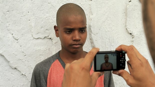 An official of the International Organisation for Migration takes a photo of a Rohingya refugee in Medan, North Sumatra.