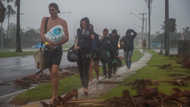 Backpackers from England, Germany and Finland leave the Bowen cyclone evacuation centre.