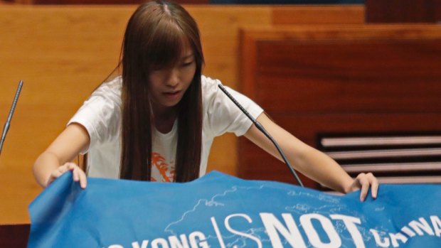 Newly elected lawmake Yau Wai-ching displays a banner with words reading "Hong Kong is not China" as she takes oath in the new legislature Council in Hong Kong in October.