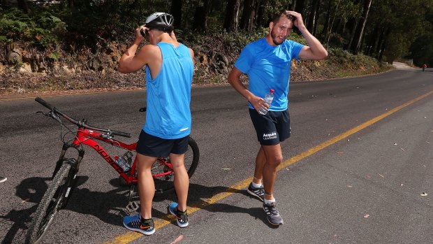 Aiming high: An exhausted Dale Thomas during the Carlton players’ ride up Mount Buller Road. 