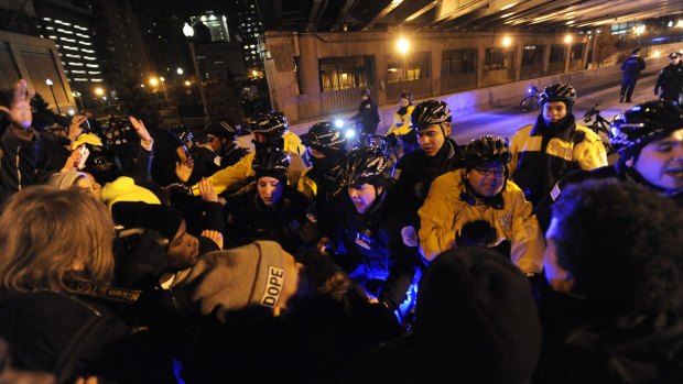 Protesters scuffle with Chicago police while trying to enter an expressway on Tuesday in Chicago. 