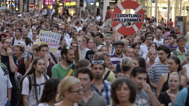 Protesters in Vienna welcome refugees and push for a change to government policy. 