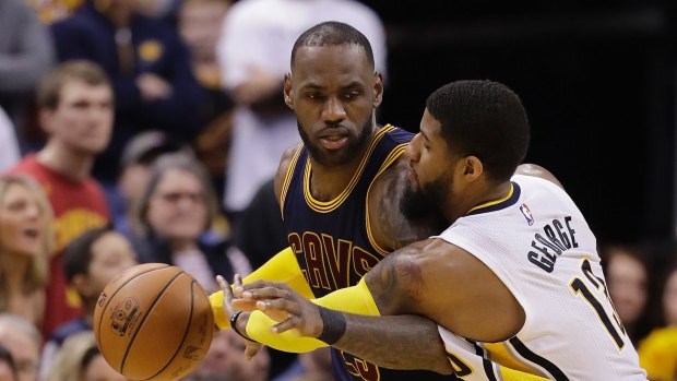 Cleveland Cavaliers' LeBron James is defended by Indiana Pacers' Paul George.