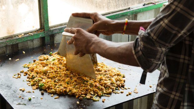 Preparing Kottu roti in a roadside restaurant, Jaffna, Sri Lanka.