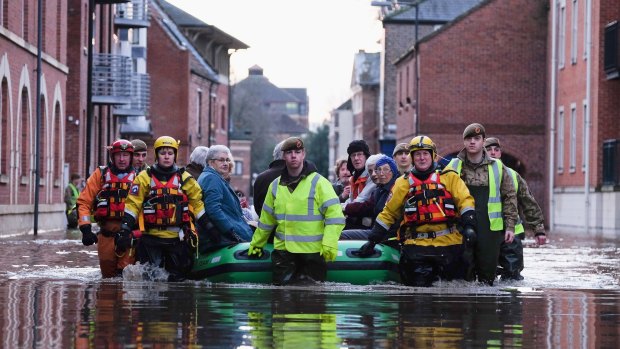 Rescuers and soldiers assist members of the public as they are evacuated from the Queens Hotel in York city centre as the River Ouse floods on December 27, 2015 in York, England. 