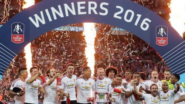 Silverware: The Manchester United team celebrates with the trophy after winning the FA Cup final.