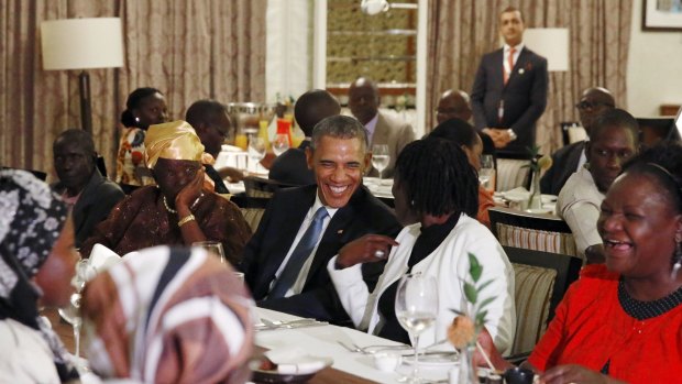 President Barack Obama attends a private dinner with family members at his hotel restaurant after arriving in Nairobi.