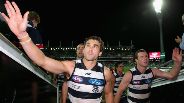 Corey Enright and Steve Johnson leave the ground together after a Geelong win in 2013.