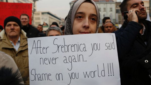 A Bosnian woman holds a banner during an Aleppo solidarity rally in Sarajevo on Wednesday.